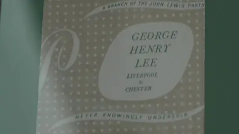 A paper bag bearing the words 'George Henry Lee - Liverpool & Chester'