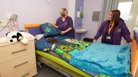 Dean Atkins/Bluebell Wood Children's Hospice Two nurses stand by a bed