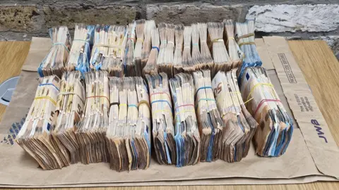 An Garda Síochána  Piles of Euro notes lined up on a table 