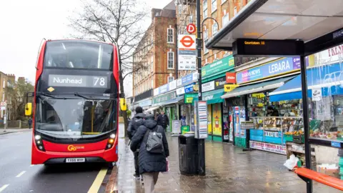 A bus stop in Peckham and a No 78 red double decker bus