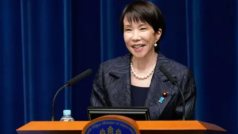 AFP via Getty Images Japan's new Prime Minister Sanae Takaichi speaks during a press conference at the prime minister's office in Tokyo on October 21, 2025.