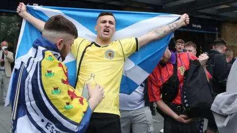 PA Media fans in King's Cross Station on Friday