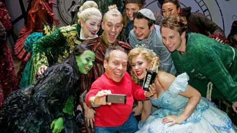 Troy David Johnston/Wicked London Productions  Warwick Davis and the cast of Wicked