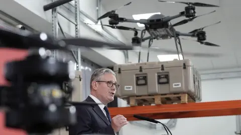 Getty Images Sir Keir Starmer speaking in front of a drone. 