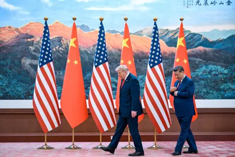 AFP via Getty Images China's President Xi Jinping (R) receives US President Donald Trump after a welcome ceremony at the Great Hall of the People in Beijing on May 14, 2026.