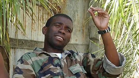 Getty Images Guy Philippe speaks to journalist in Gonaives 20 February 2004.