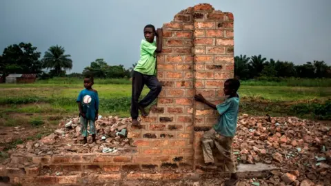 AFP - Young Congolese boys play around broken building on October 26, 2017 in Kasala, in the restive region of Kasai, central Democratic Republic of Congo. Conflict in the Kasai Provinces between the local militia, Kamwina Nsapu and Government troops have displaced 1.4 million people since August, 2016. As three crop cycles have been missed and displacement continues, sever malnutrition is becoming a present issue.