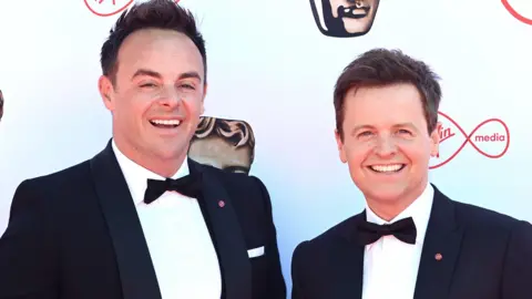 Getty Images Ant and Dec wearing dark suits and bow ties