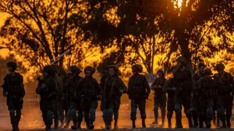 EPA Israeli soldiers patrol the area of an attack that killed more than 260 people at a music festival