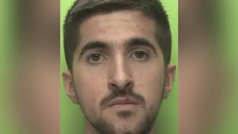 Nottinghamshire Police Headshot of Gezim Celaj, who has a short dark beard and short dark hair.