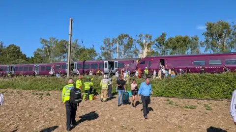 Alex Knight People leaving train following Bedford train crash