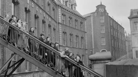 Bert Hardy/getty images Workers leaving the Tillie and Henderson's shirt factory in November 1955