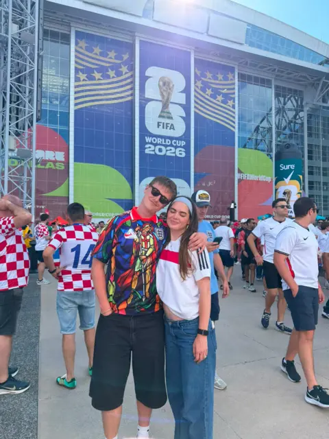 Ellis Platten Picture of football content creator Ellis Platten in a colourful England shirt with his partner Rose Ruland who is wearing a white and red England shirt