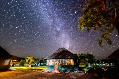 Getty Images The night sky at a campsite in the Hwange National Park covered in billions of stars.