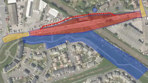 North Somerset Council An aerial view of the bridge, railway and surrounding area. There are areas marked out in red showing where the bridge will be replaced, and a red dotted line parallel to it showing where a temporary footbridge will be in place during the main demolition and construction works. 