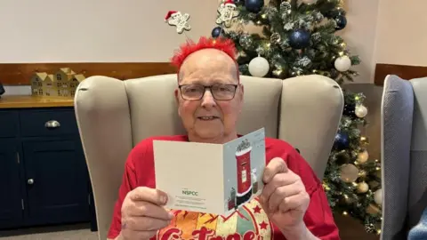 A man holding a Christmas card