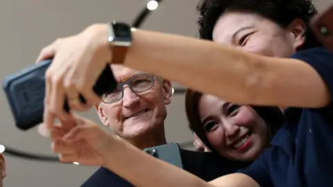 Getty Images Apple CEO Tim Cook takes a selfie with attendees during an Apple special event on September 10, 2019 in Cupertino, Califo