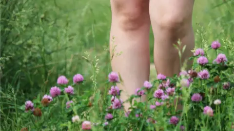 Getty Images bare legs in the grass