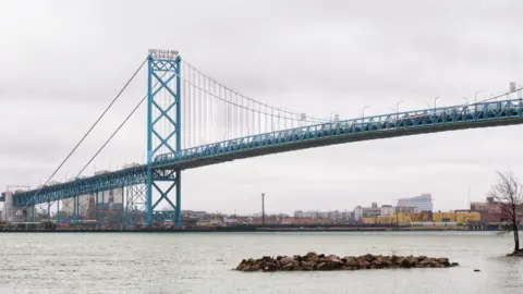 Ali Abbas Ahmad/BBC A view of the Ambassador Bridge from Windsor, with the Detroit River flowing under it