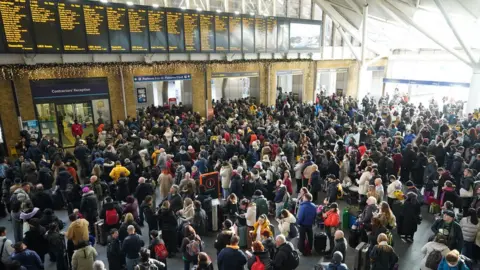 PA Media Crowds formed at Kings Cross Station