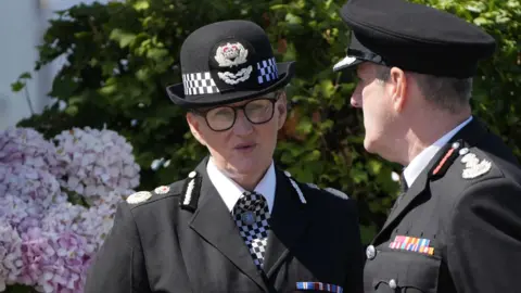 PA Media Chief Constable Serena Kennedy speaks to a colleague outside the church