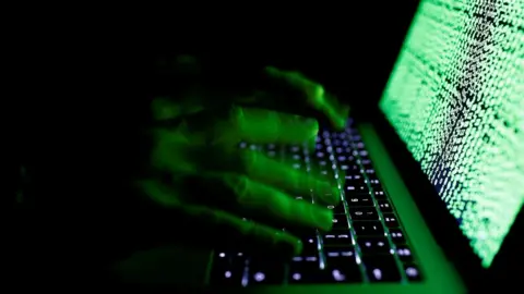 Reuters Man using computer keyboard