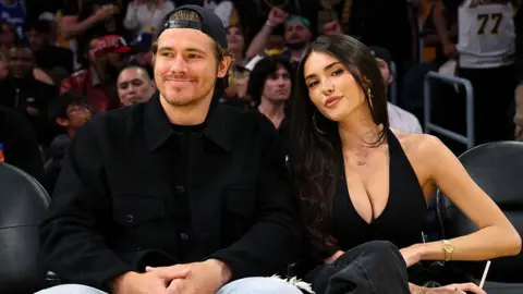 Quarterback Justin Herbert #10 of the Los Angeles Chargers and Madison Beer attend a basketball game between Los Angeles Lakers and Minnesota Timberwolves at Crypto.com Arena on October 24, 2025 in Los Angeles, California.
