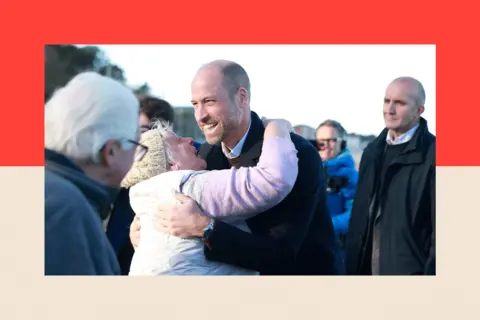 AFP via Getty Images Prince of Wales hugs a well-wisher during a visit to the beach at Colwyn Bay, Wales