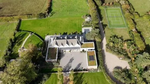 Qays Najm/BBC A drone image of Larkfield in Blakeney, showing the house, extensions, tennis court, swimming pool and lawns and wild grasslands around.