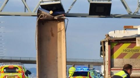 picture shows lorry bed wedged under gantry 