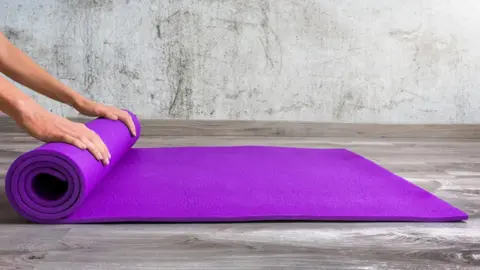 Getty Images Yoga mat being rolled