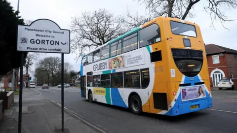 Reuters A bus drives past a signage for Gorton, as the northwest region of Gorton and Denton