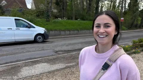 Pippa Francis standing by the side of a road