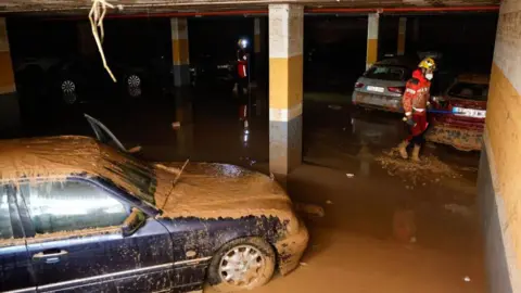 EPA a car covered in mud in an underground car park in Sedavi near Valencia