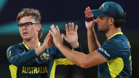 Australia bowler Adam Zampa celebrates a wicket with Marcus Stoinis against Namibia at the T20 World Cup