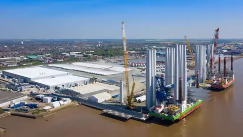 The Siemans Gamesa factory at Alexandra Dock taken from above. The factory buildings are on a plot of land along with several large cranes on the site.