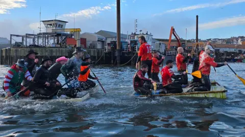 Scarborough Sub Aqua Club Two rafts with several crew members on board racing each other at sea in Scarborough  