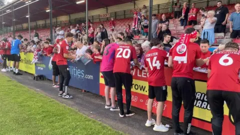 BBC/Daniel Sexton Crawley players sign autographs for fans