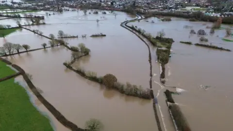 PA Media An aerial image showing a deluge of water in Axminster, Devon.