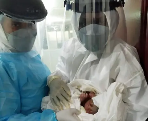 Yaneu Ngaha Bondja Junie L-R: Dr Yaneu Ngaha Bondja Junie and Dr Kemme Marilene at the Yaoundé General Hospital holding the newborn