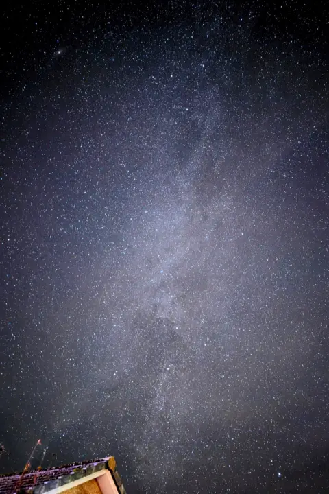 Pete Walls The stars in the sky above a house.