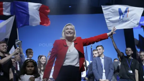 Getty Images Marine Le Pen waves her supporters at the end of her electoral campaign rally on April 14, 2022 in Avignon