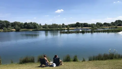 BBC Two women in deckchairs overlooking water at Box End Park