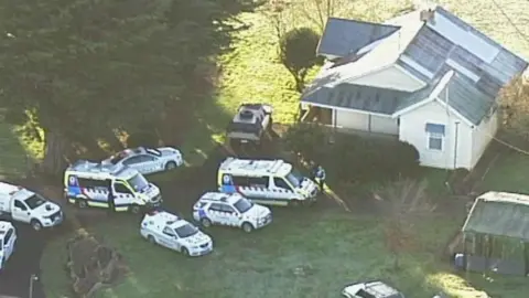 AUSTRALIAN BROADCASTING CORP Police and ambulance vehicles outside the house where the dog attack took place