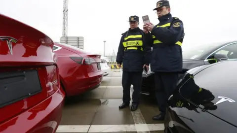 Getty Images China custom officers examine Tesla Model 3 cars