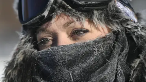 EPA A woman in Minneapolis bundled up in ski gear