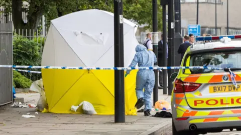 Getty Images Police at scene of stabbing in London