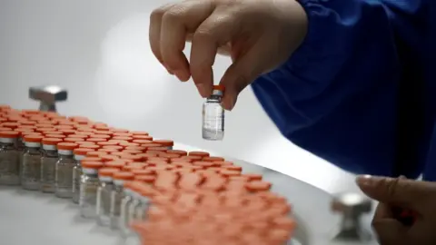 Reuters A worker performs a quality check in the packaging facility of Chinese vaccine maker Sinovac Biotech in September 2020