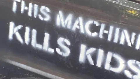 Brian Latham Car with 'this machine kills kids' written on the side