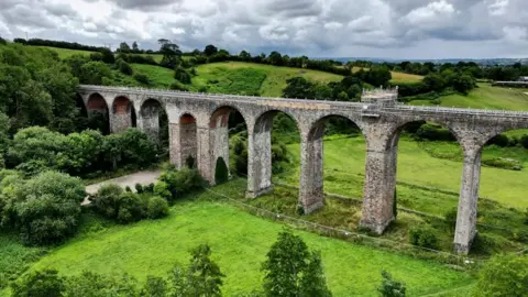 Pensford Viaduct. The image shows the viaduct spanning across miles of green fields.